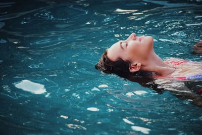 Swimmer floating in crystal-clear pool water