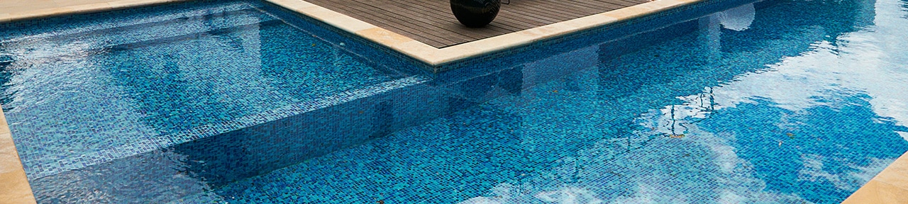 Blue mosaic pool with hardwood deck